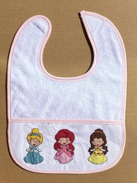 A set of 6 baby bib cross stitch kits with pink edges, perfect for gifting expectant moms.