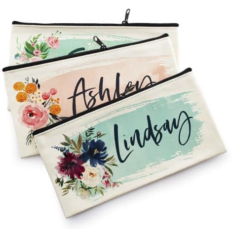 A collection of three personalized cosmetic bags in nine color options, perfect for asking your bridesmaids.